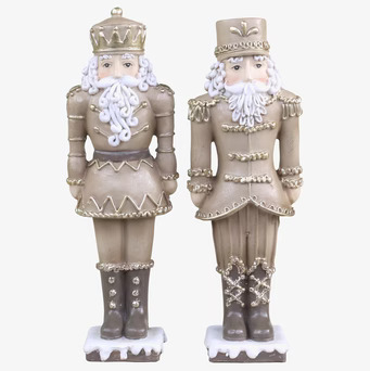 Bild av två dekorativa nötknäppare i guld och mocca