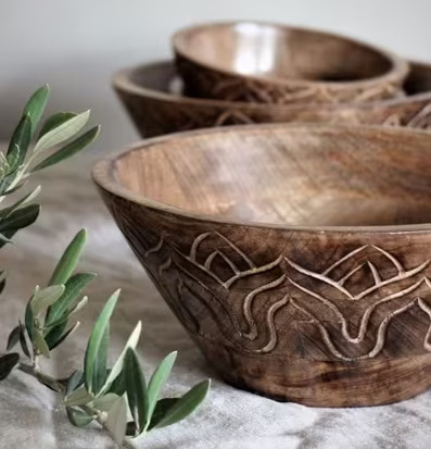 Bild av träskålar med handgjorda mönster och olivkvistar