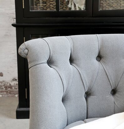Foto av stilfull grå soffa med klassisk knappdetaljering