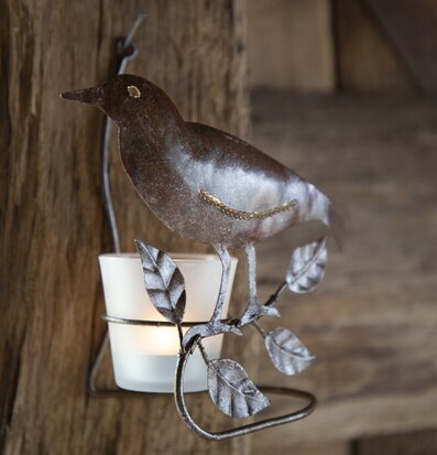 Bild av dekorativ ljuslykta med fågel och kvistar