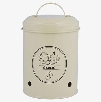 Bild av krämfärgad plåtburk för vitlöksförvaring