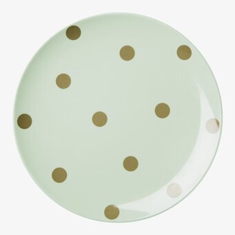 Foto av elegant tallrik med guldprickar och pastellgrönt