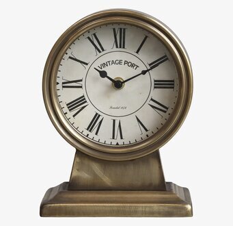 Foto av antik bordsklocka i mässing med romerska siffror