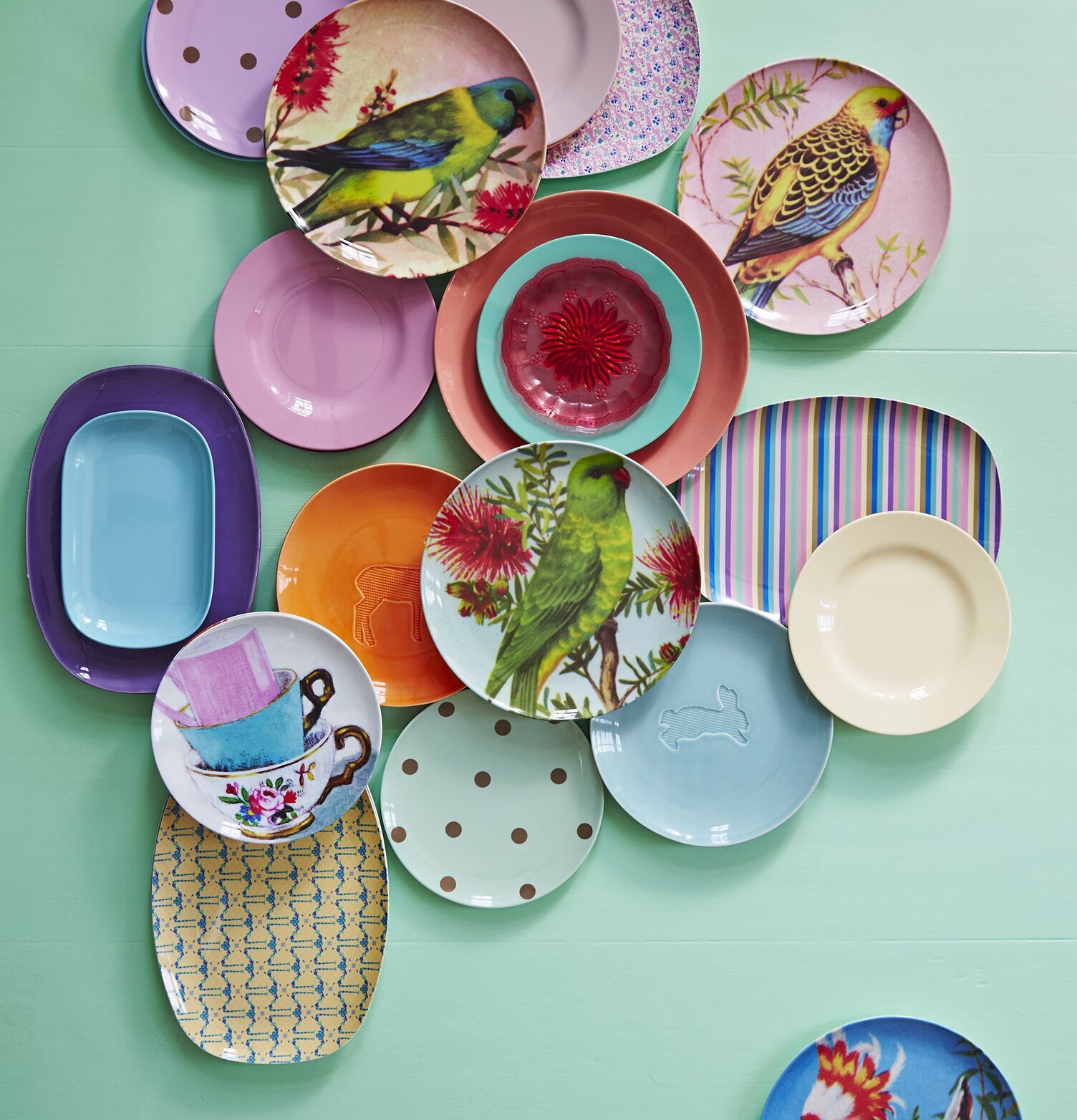 Bild av färgglada tallrikar med fågelmotiv och mönster