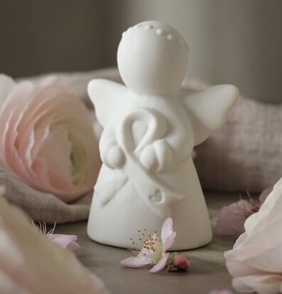 Bild av ängel med rosa bandet-emblem och blommor