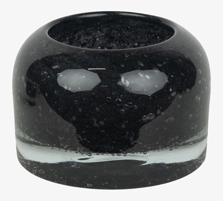 Bild av stilren svart ljuskopp i glas med bubblor