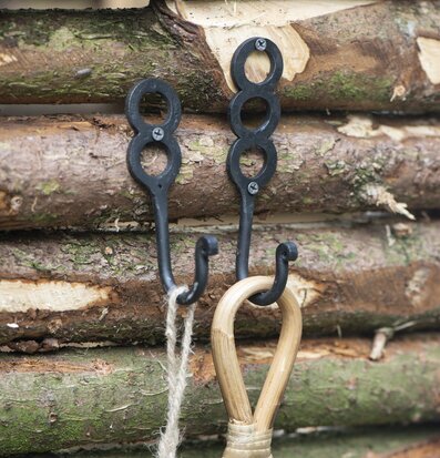 Bild av rustika krokar i smidesjärn och trästockar
