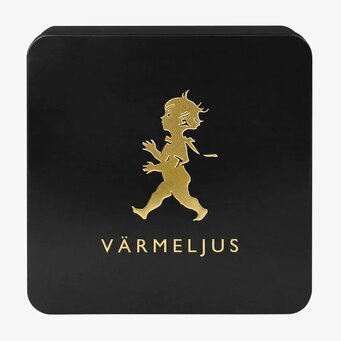 Bild av stilren plåtburk för värmeljus i svart och guld