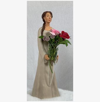 Foto av elegant figurin med tidlös design och blommor