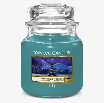 Bild av doftljus i glas med vintertema och stjärnor