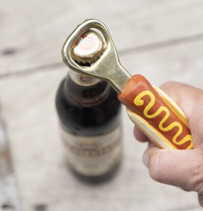 Foto av lekfull korvformad kapsylöppnare i hand