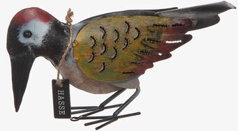 Bild av en detaljerad fågelfigur i hamrad plåt