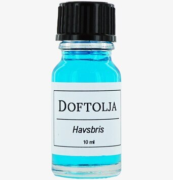 Bild av en blå doftolja i glasflaska med etikett