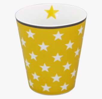 Bild av livfull gul mugg med vita stjärnor i porslin