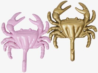 Bild av krabbformade väggkrokar i rosa och guld