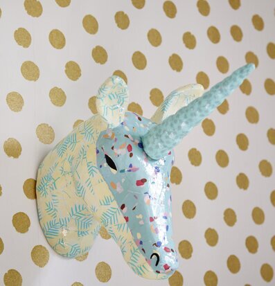 Foto av färgglad enhörningsskulptur i papier maché