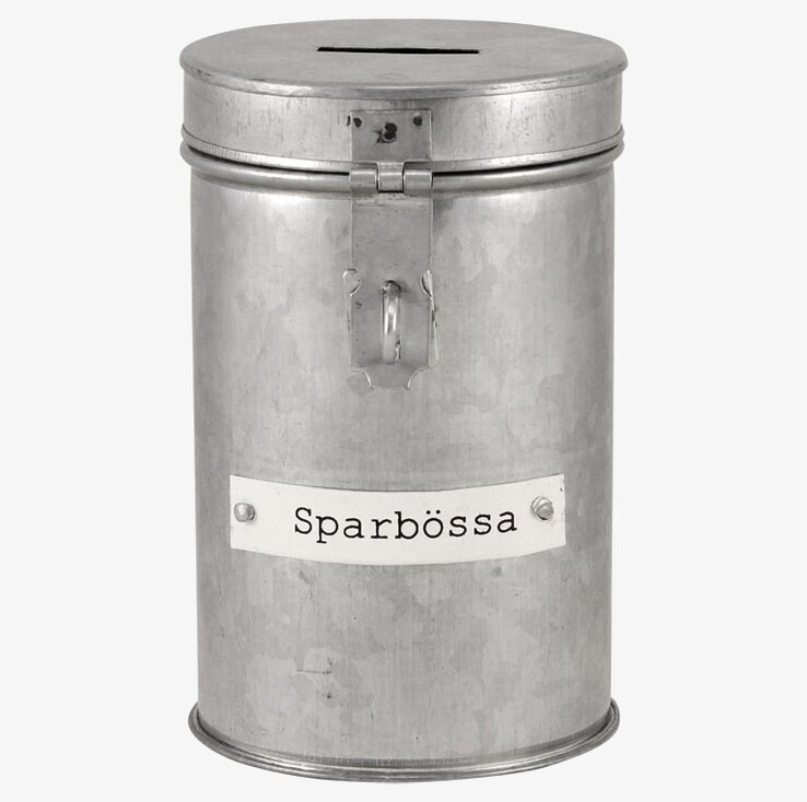 Foto av cylindrisk sparbössa i rustik, industriell stil