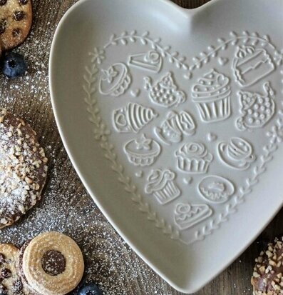 Bild av ett vackert arrangerat fikabord med hjärtfat