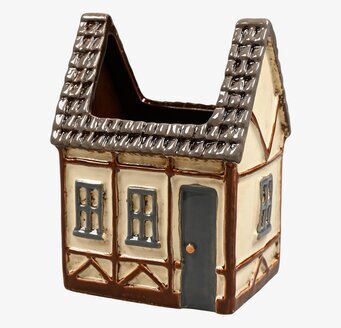 Foto av charmig keramikvas formad som ett litet hus