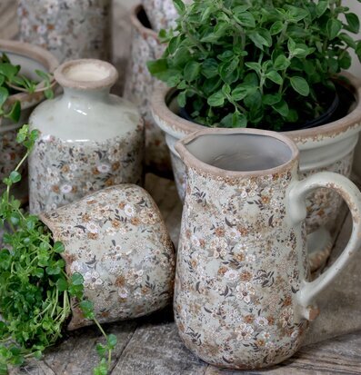 Foto av rustik keramik med blommönster och växter