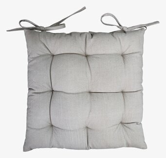 Foto av en kviltad stolsdyna i linneinspirerat tyg