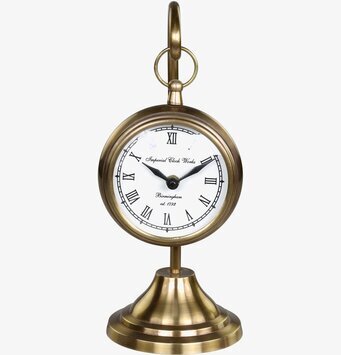 Bild av dekorativ klocka i mässing med romerska siffror