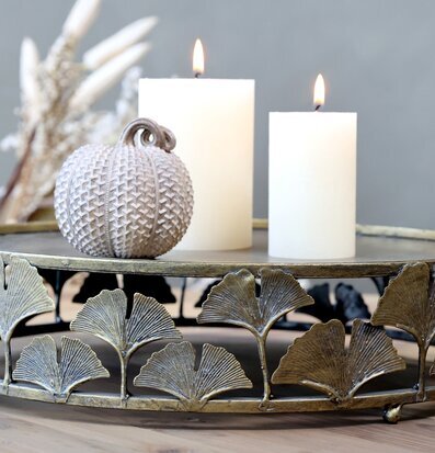 Bild av dekorativt fat med ljus och pumpa i fokus