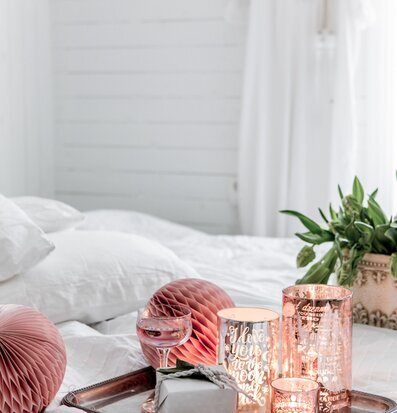 Bild av harmonisk inredning med ljuslyktor och rosétoner