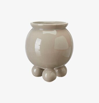 Bild av elegant, minimalistisk beige kruka med fötter