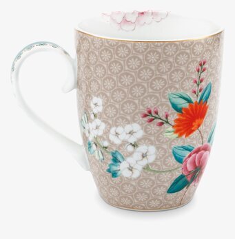 Bild av mugg med intrikat blommönster och khakifärg