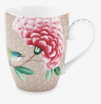 Bild av mugg med blommor och fågel, elegant design