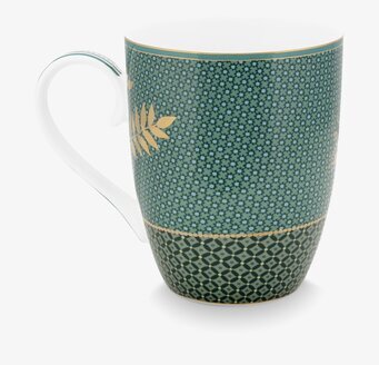 Bild av grön mugg med gyllene detaljer och mönster