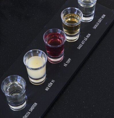 Bild av elegant träbricka med färgglada shotglas