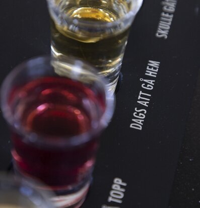 Bild av elegant träbricka med tre färgglada shotglas