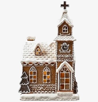 Foto av pepparkakskyrka med LED-belysning och snö