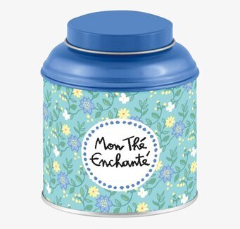 Bild av rund plåtburk med blommönster för teförvaring