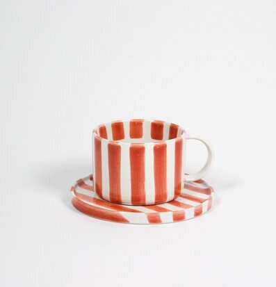 Bild av stilren kopp med fat i modern keramikdesign