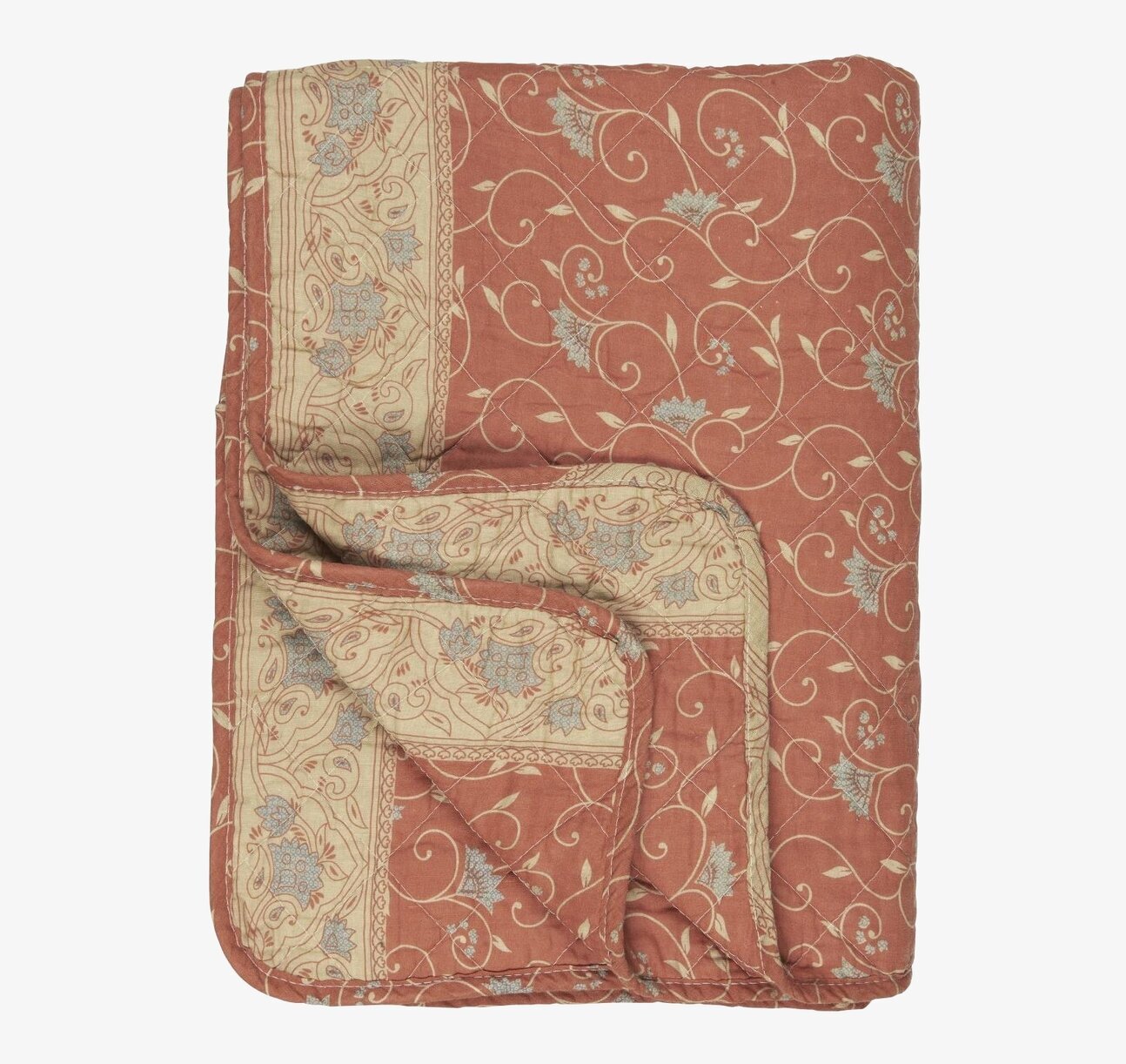 Bild av quilt med jordnära färger och blommönster