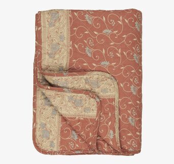 Bild av quilt med jordnära färger och blommönster