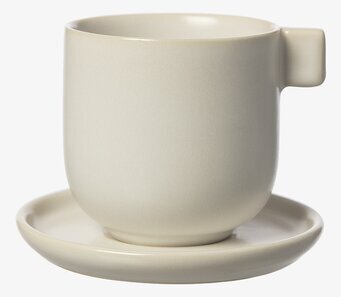 Bild av stilren kaffekopp med fat i vit sandfärg