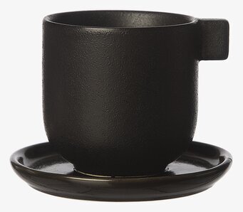 Foto av elegant kaffekopp med fat i svart design