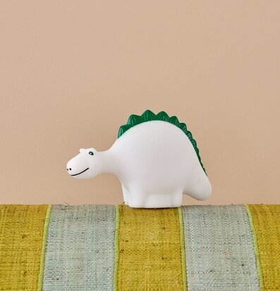 Foto av LED-lampa i dinosaurieform med gröna detaljer