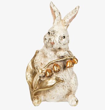 Foto av detaljrik skulptur med kanin och liljekonvalj