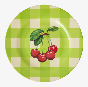 Bild av assiett med körsbärsmönster och grön bakgrund