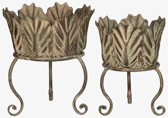 Foto av gröna metallkrukor med bladmotiv på ben