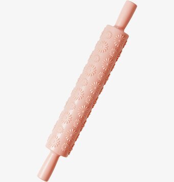 Foto av dekorativ kavel med blommönster och aprikosfärg