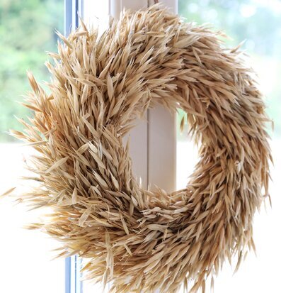 Bild av naturlig väggkrans i fönsterram med grönska