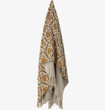 Bild av färgglad pläd med blommönster och fransar