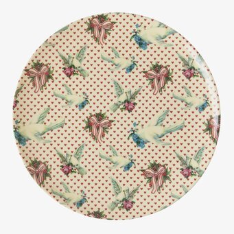 Bild av detaljrik assiett med duvmotiv och blommor