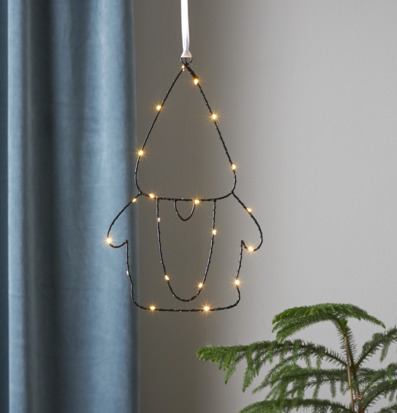 Bild av dekorativ tomte med LED-ljus och växt i rum